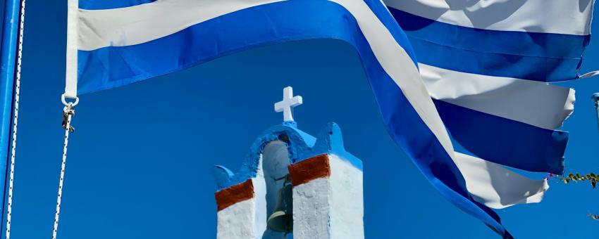 The Greek flag outside a Greek Orthodox Church in Santorini, Greece.