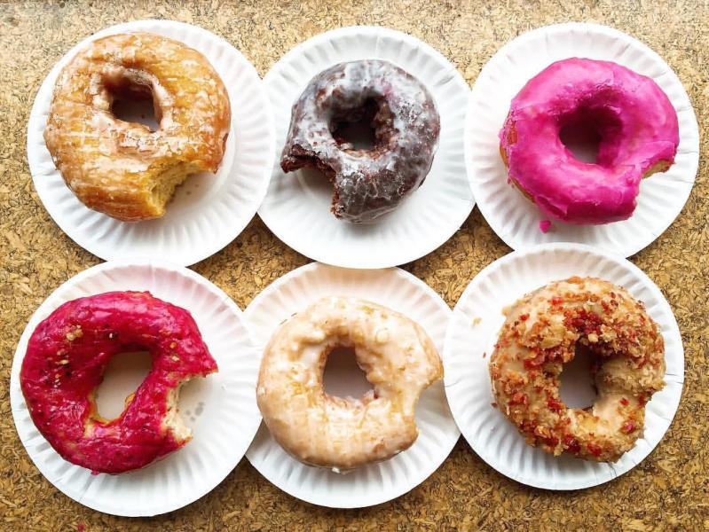 Sweet potato ginger glazed, sea salt chocolate, pomegranate, maple bacon, fresh lemon, and triple berry potato donuts from The Holy Donut